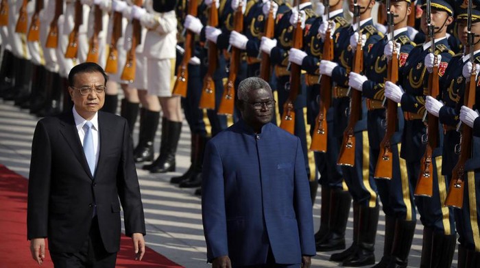 FILE - Chinese Premier Li Keqiang, left, and Solomon Islands Prime Minister Manasseh Sogavare review an honor guard during a welcome ceremony at the Great Hall of the People in Beijing, Wednesday, Oct. 9, 2019. The U.S. on Monday, April 18, 2022, announced it is sending two top officials to the Solomon Islands following a visit last week by an Australian senator over concerns that China could establish a military presence in the South Pacific island nation. (AP Photo/Mark Schiefelbein, File)
