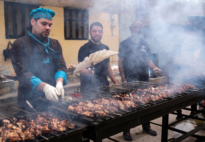 Residents of Ezbet Hamada gather to eat during Iftar gathering, a meal to end their fast at sunset, during the holy fasting month of Ramadan in Mataria, Cairo, Egypt, April 16, 2022. Picture taken April 16, 2022. REUTERS/ Fatma Fahmy NO RESALES. NO ARCHIVES
