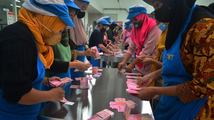 Semringah! Buruh Pabrik Rokok Djarum Terima THR Pekerja menghitung uang Tunjangan Hari Raya (THR) yang diterimanya di pabrik rokok PT Djarum, Kudus, Jawa Tengah, Selasa (19/4/2022). Sebanyak 52.025 pekerja harian dan borongan yang tersebar di tujuh kota di perusahaan itu telah menerima uang THR guna membantu mereka dalam memenuhi kebutuhan keluarga selama bulan Ramadhan dan Idul Fitri. ANTARA FOTO/Yusuf Nugroho/wsj.