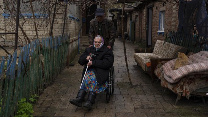 Elderly people are evacuated from a hospice in Chasiv Yar city, Donetsk district, Ukraine, Monday, April 18, 2022. At least 35 men and women, some in wheelchairs and most of them with difficulties to walk, were helped by volunteers to flee from the region that has been under attack in the last weeks. They are going to Khmelnytskyi, western Ukraine. (AP Photo/Petros Giannakouris)