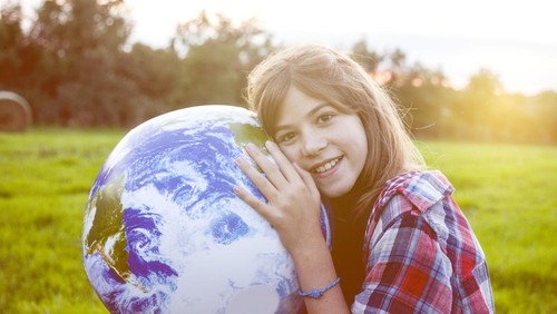 Girl embracing globe