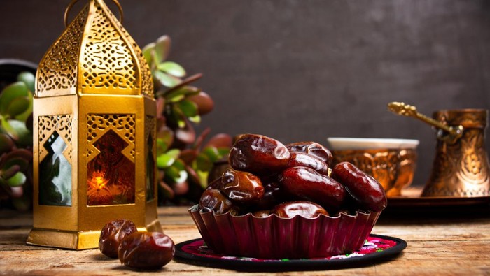 Dates and Arabic style lamp on a table with copy space