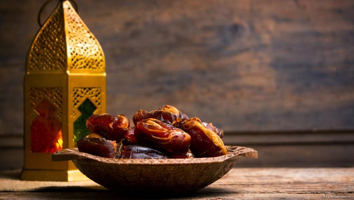 Fresh date fruits with almonds on a table