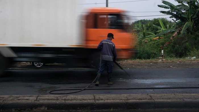 Pekerja melakukan pengaspalan dan perawatan jalan raya di jalur Pantura Kabupaten Pekalongan, Jawa Tengah, Selasa (19/4/2022). Balai Besar Pelaksanaan Jalan Nasional Jawa Tengah-DIY Satuan Kerja Pelaksanaan Jalan Nasional (Satker PJN) 1 melakukan pengaspalan dan perawatan jalan di jalur Pantura Batang sepanjang 970 meter, Pekalongan sepanjang 400 meter, dan lingkar Pemalang 800 meter dengan target pada H-10 Lebaran sudah selesai pengerjaan untuk memberikan kenyamanan pemudik saat melintas di Jalur Pantura Jawa Tengah. ANTARA FOTO/Harviyan Perdana Putra/nym.