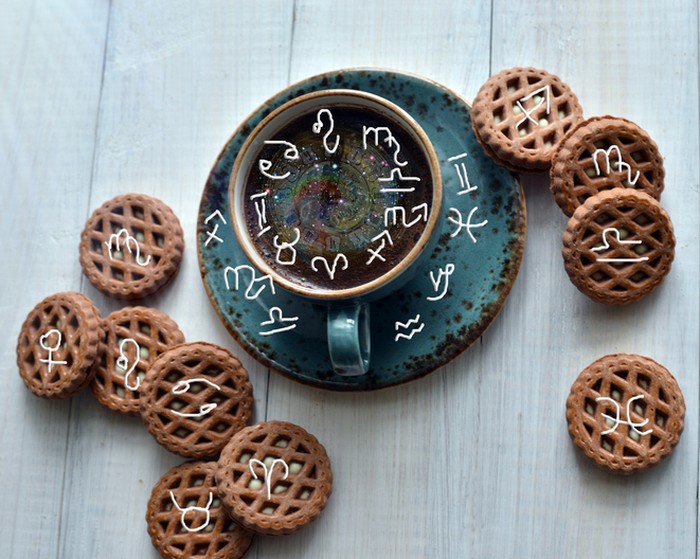 Coffee with cookies and astrological zodiac symbols