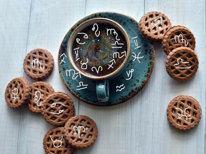 Coffee with cookies and astrological zodiac symbols