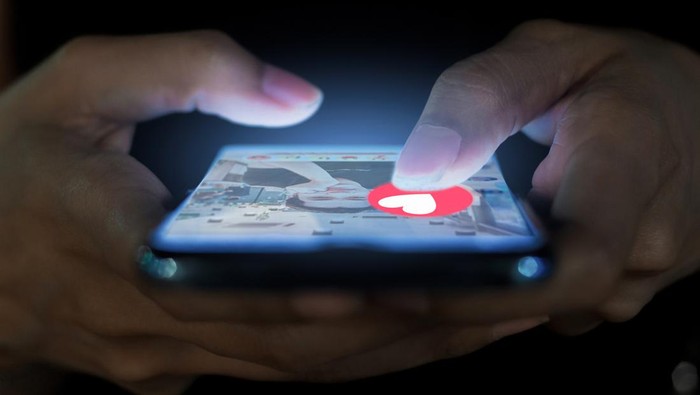 A woman using a phone for a dating app