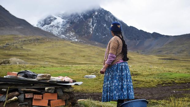A woman prepares food at the inauguration of tourist season at the Charquini glacier, as scientists and climbers battle over the future of the controversial lure for tourists, outside of El Alto, Bolivia April 8, 2022. Picture taken April 8, 2022. REUTERS/Claudia Morales