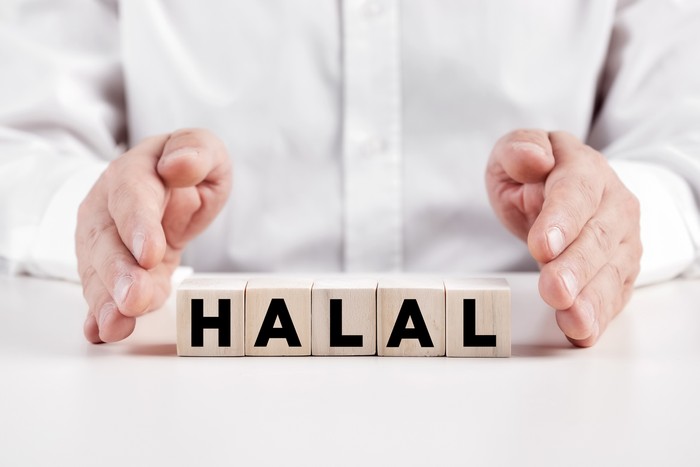 asian muslim woman buying halal food in a supermarket