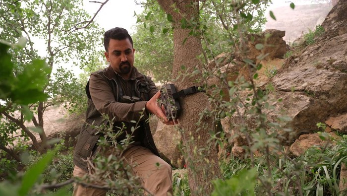 IRAQ-CONSERVATION/PERSIAN LEOPARD Two environmentalists brothers look at the Bamo mountain to find a spot for their camera traps, in the mission to protect the leopards, near Darbandikhan, Iraq, April 9, 2022. Picture taken April 9, 2022. REUTERS/Mohammed Jalal NO RESALES. NO ARCHIVES