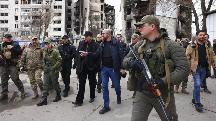 In this image provided by the European Council, European Council President Charles Michel, left, speaks with a woman as he is given a tour of the region of Borodyanka, Ukraine, Wednesday, April 20, 2022. (Dario Pignatelli/European Council via AP)