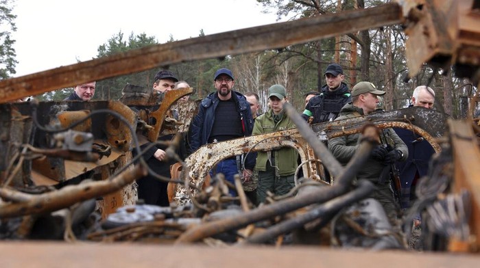 Russia Ukraine War In this image provided by the European Council, European Council President Charles Michel, left, speaks with a woman as he is given a tour of the region of Borodyanka, Ukraine, Wednesday, April 20, 2022. (Dario Pignatelli/European Council via AP)