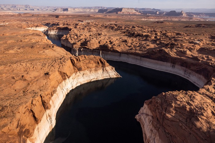 Kayaks are seen on the shore of Lake Powell, where water levels have declined dramatically to lows not seen since it was filled in the 1960s as growing demand for water and climate change shrink the Colorado River and create challenges for business owners and recreation in Page, Arizona, U.S., April 19, 2022. REUTERS/Caitlin Ochs
