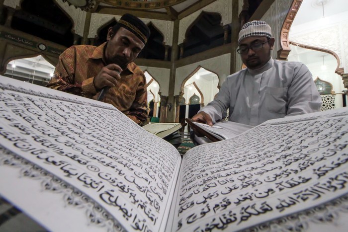 Pengurus remaja masjid membaca Al Quran di Masjid Syuhada Lhokseumawe, Aceh, Selasa (12/4/2022) malam. Remaja masjid kembali aktif melaksanakan ibadah tadarus Ramadhan 1443 Hijriah setelah adanya pelonggaran PPKM COVID-19 dari pemerintah. ANTARA FOTO/Rahmad/wsj.