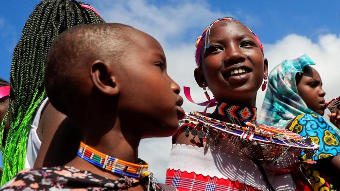Felistar Titian from the indigenous Maasai community carries oil to bless the girls during an alternative rite of passage into adulthood, shunning the traditional genital mutilation which has been outlawed in Kiloh village of Imaroro location in Kajiado county, Kenya April 8, 2022. Picture taken April 8, 2022. REUTERS/Thomas Mukoya