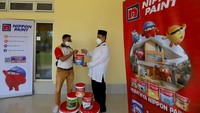 Regional Sales Manager Nippon Paint Indonesia, Sepriyadi menyerahkan secara simbolis donasi berupa kaleng cat kepada Ketua DKM Masjid Nurul Ilmi, Taudi di Cakung, Jakarta Timur, Sabtu (23/4/2022).   