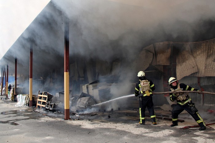 A firefighter runs as he participates in efforts to extinguish a fire that broke out in a steel warehouse following a military strike, amid Russias invasion of Ukraine, in Kharkiv, Ukraine, April 23, 2022. REUTERS/Oleksandr Lapshyn