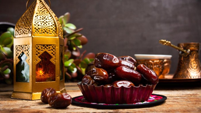 Dates and Arabic style lamp on a table with copy space