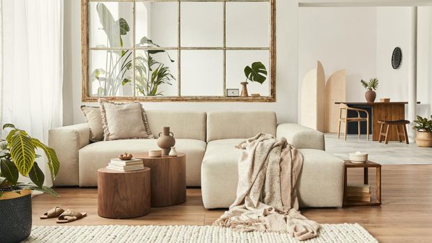 Modern interior of open space with design modular sofa, furniture and elegant personal accessories in stylish home decor. Neutral living room.
