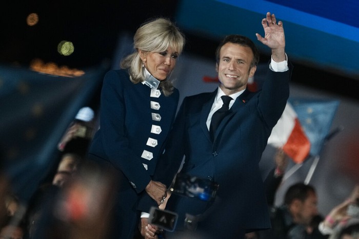 French President Emmanuel Macron and French first lady Brigitte Macron celebrate with supporters in Paris, France, Sunday, April 24, 2022. Polling agencies projected that French President Emmanuel Macron comfortably won reelection Sunday in the presidential runoff, offering French voters and the European Union the reassurance of leadership stability in the blocs only nuclear-armed power as the continent grapples with Russias invasion of Ukraine.
