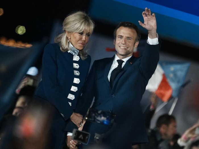 French President Emmanuel Macron and French first lady Brigitte Macron celebrate with supporters in Paris, France, Sunday, April 24, 2022. Polling agencies projected that French President Emmanuel Macron comfortably won reelection Sunday in the presidential runoff, offering French voters and the European Union the reassurance of leadership stability in the blocs only nuclear-armed power as the continent grapples with Russias invasion of Ukraine.