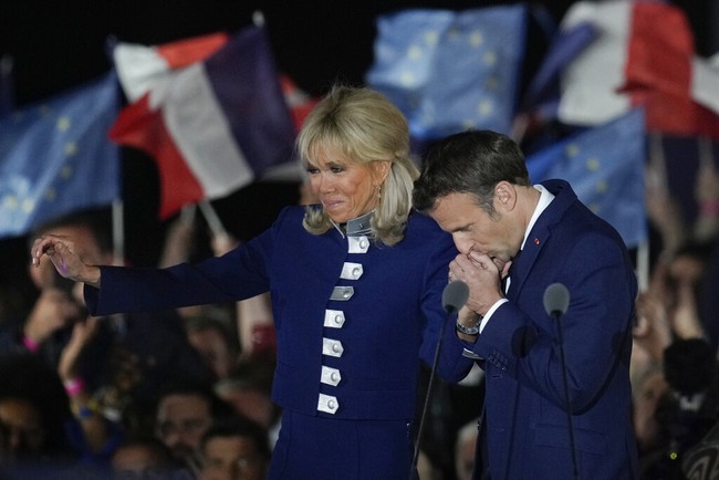 French President Emmanuel Macron and French first lady Brigitte Macron celebrate with supporters in Paris, France, Sunday, April 24, 2022. Polling agencies projected that French President Emmanuel Macron comfortably won reelection Sunday in the presidential runoff, offering French voters and the European Union the reassurance of leadership stability in the blocs only nuclear-armed power as the continent grapples with Russias invasion of Ukraine.