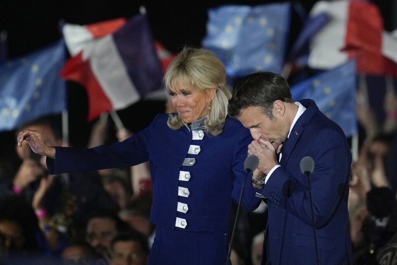 French President Emmanuel Macron and French first lady Brigitte Macron celebrate with supporters in Paris, France, Sunday, April 24, 2022. Polling agencies projected that French President Emmanuel Macron comfortably won reelection Sunday in the presidential runoff, offering French voters and the European Union the reassurance of leadership stability in the bloc's only nuclear-armed power as the continent grapples with Russia's invasion of Ukraine.