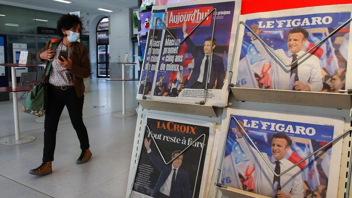 Newspapers headlining with French President Emmanuel Macron's victory in the presidential election are pictured in Hendaye, southwestern France, Monday, April 25, 2022. After winning another five years in the French presidential palace, Emmanuel Macron intends to go back to work straightaway on domestic and foreign policy, but he will soon face crucial parliamentary elections where he may struggle to keep his majority. (AP Photo/Bob Edme)