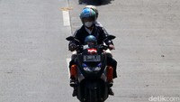 Beberapa pemudik bermotor terlihat melintas dengan kecepatan sedang.