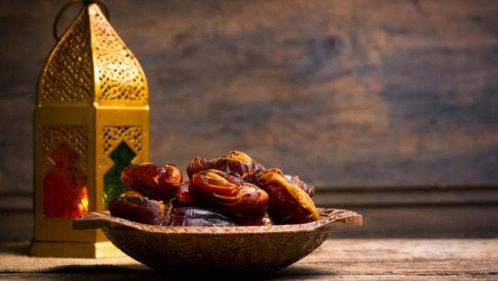 Fresh date fruits with almonds on a table