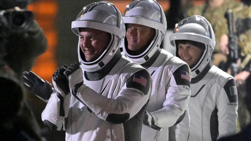 NASA astronauts Kjell Lindgren, Robert Hines, and European Space Agency astronaut Samantha Cristoforetti of Italy depart their crew quarters for their launch on a SpaceX Falcon 9 rocket to begin a six-month expedition on the International Space Station, at Cape Canaveral, Florida, U.S. April 27, 2022. REUTERS/Steve Nesius