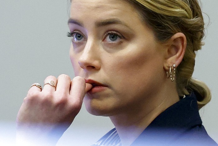 Persidangan Johnny Depp dan Amber Heard Actor Johnny Depp watches a pre-recorded deposition testimony of Christian Carino at the Fairfax County Circuit Court in Fairfax, Va., Wednesday, April 27, 2022. Depp sued his ex-wife actress Amber Heard for libel in Fairfax County Circuit Court after she wrote an op-ed piece in The Washington Post in 2018 referring to herself as a