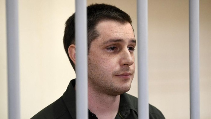 (FILES) In this file photo taken on March 11, 2020 US ex-marine Trevor Reed, charged with attacking police, stands inside a defendants cage during a court hearing in Moscow. - Moscow said on April 27, 2022 it has exchanged former US marine Trevor Reed, jailed in Russia for assaulting police, for Russian pilot Konstantin Yaroshenko, who was convicted of drug smuggling in the United States. (Photo by Alexander NEMENOV / AFP)