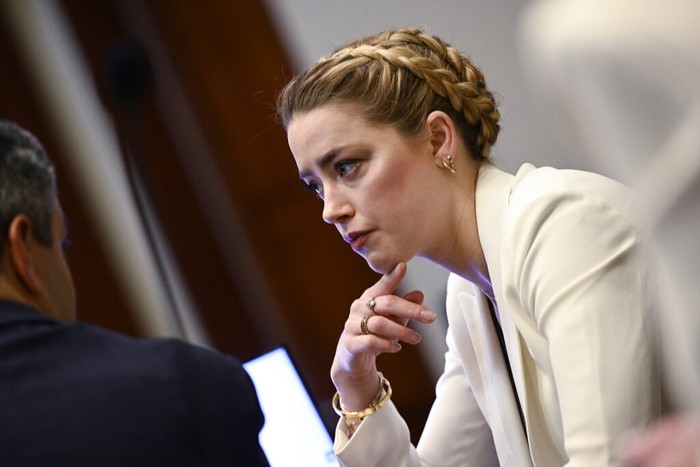 Actress Amber Heard appears in the courtroom during a hearing at the Fairfax County Circuit Court in Fairfax, Va., Tuesday April 19, 2022. Actor Johnny Depp sued his ex-wife Heard for libel in Fairfax County Circuit Court after she wrote an op-ed piece in The Washington Post in 2018 referring to herself as a public figure representing domestic abuse. (Jim Watson/Pool Photo via AP)