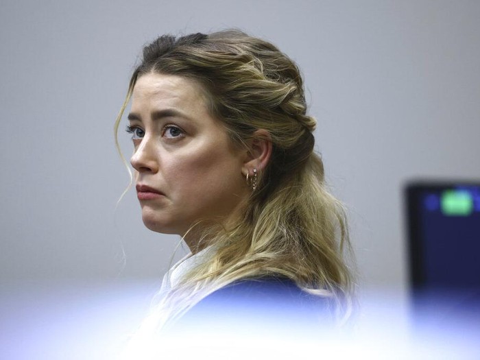 Actress Amber Heard appears in the courtroom during a hearing at the Fairfax County Circuit Court in Fairfax, Va., Tuesday April 19, 2022. Actor Johnny Depp sued his ex-wife Heard for libel in Fairfax County Circuit Court after she wrote an op-ed piece in The Washington Post in 2018 referring to herself as a 