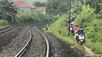 Pemudik motor akhirnya nekat memilih jalan alternatif di sisi rel kereta. 