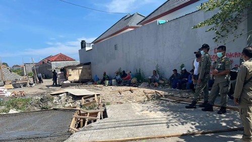 Petugas dari Satpol PP Kkota Denpasar saat mendatangi proyek cor saluran air di kawasan Kepaon, Denpasar Selatan