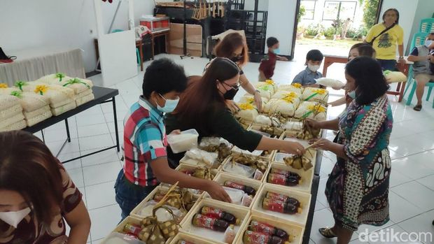 Anak-anak Bina Iman Gereja Santo Yohanes membuat dan membagikan ketupat lebaran untuk warga muslim.