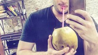 Kelapa muda memang segar dan menggoda. Apalagi dinikmati ketika siang hari saat cuaca panas terik. Sebelum minum kelapa muda, ia lebih dulu berpose. Foto: Instagram @ridho_rhoma