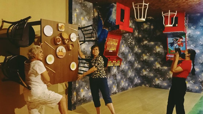 Suprapti Gunarti Ningsih bersama keluarga tampak berfoto di salah satu spot foto terbalik di Up side Down World Bali pada Selasa (3/5/2022)