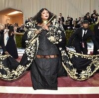 Penyanyi dan pemain flute Lizzo berbalut gaun hitam yang dibungkus jubah nan dramatis rancangan Thom Brown. Seperti dikabarkan Vogue, gaun ini memakan waktu pembuatan hingga 1.200 jam. (Foto: Evan Agostini/Invision/AP)