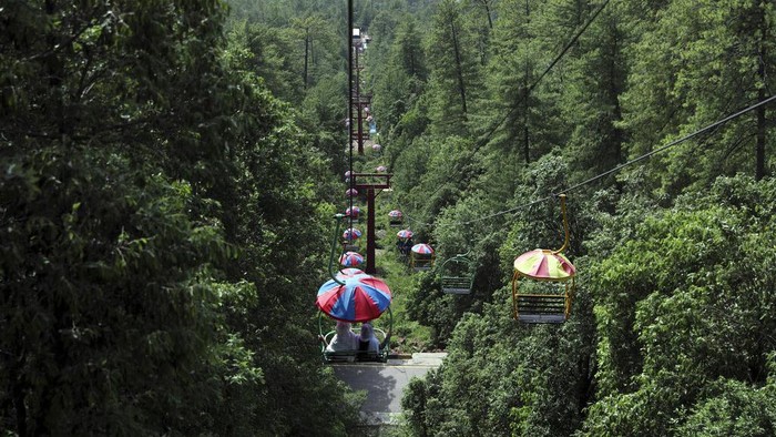 Tourists enjoy riding chairlifts at the hill resort town of Murree, during the first day of Eid al-Fitr near Islamabad, Pakistan, Tuesday, May 3, 2022. (AP Photo/Rahmat Gul)