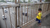 Seorang anak terlihat antusias menyaksikan kemacetan yang terjadi di tol Jakarta Cikampek.