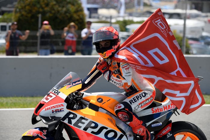 Honda Spanish rider Marc Marquez rides with a flag bearing his number at the end of the MotoGP Spanish Grand Prix at the Jerez racetrack in Jerez de la Frontera on May 1, 2022. (Photo by JORGE GUERRERO / AFP)