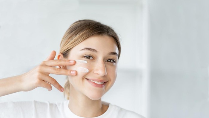 Natural beauty. Healthy skin. Dermatology hygiene. Cheerful smiling woman touching healthy fresh face on light defocused bathroom at morning.