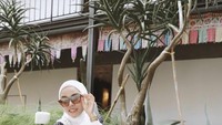 Bersantai sambil mengenakan kacamata hitam, begini gaya Medina Zein sambil menikmati minuman di pinggir kolam renang. Foto: Instagram @medinazein