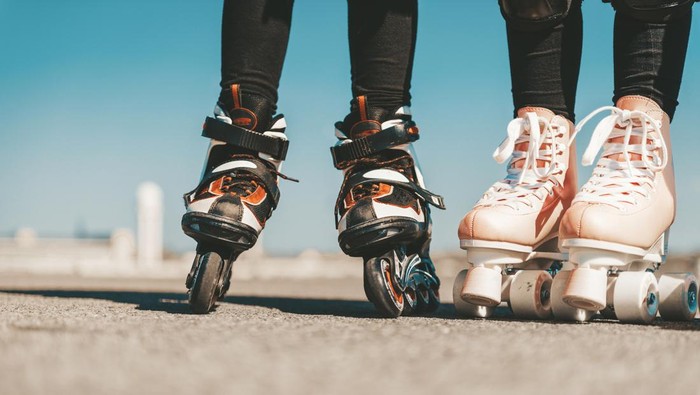 legs of two  girls on roller skates on Tempelhofer Feld in Berlin