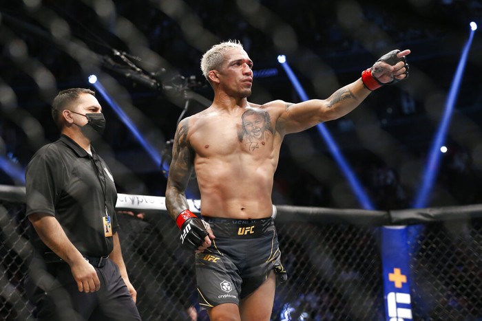 Charles Oliveira reacts after defeating Dustin Poirier, not pictured, by submission in a lightweight mixed martial arts title bout at UFC 269, Saturday, Dec. 11, 2021, in Las Vegas. (AP Photo/Chase Stevens)