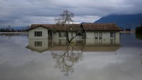 Refleksi rumah terlihat saat banjir menerjang kawasan Yarrow, Kanada, usai hujan badai. REUTERS/Jesse Winter.