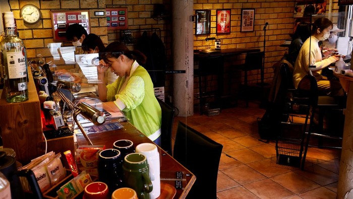 Customers work on their manuscripts at the Manuscript Writing Cafe, which is designed for writers who are working on a deadline, in Tokyo, Japan, April 21, 2022. Picture taken on April 21, 2022. REUTERS/Kim Kyung-Hoon